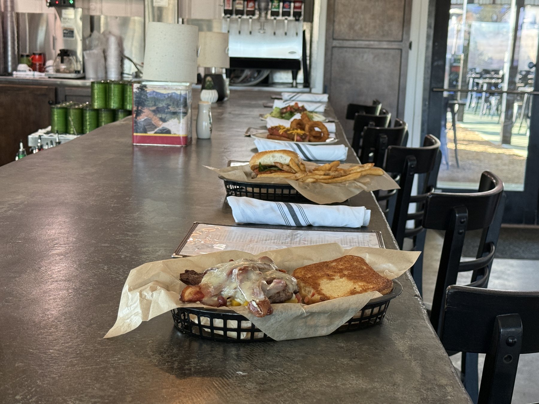 A lineup of JD’s burgers and sides across the bar